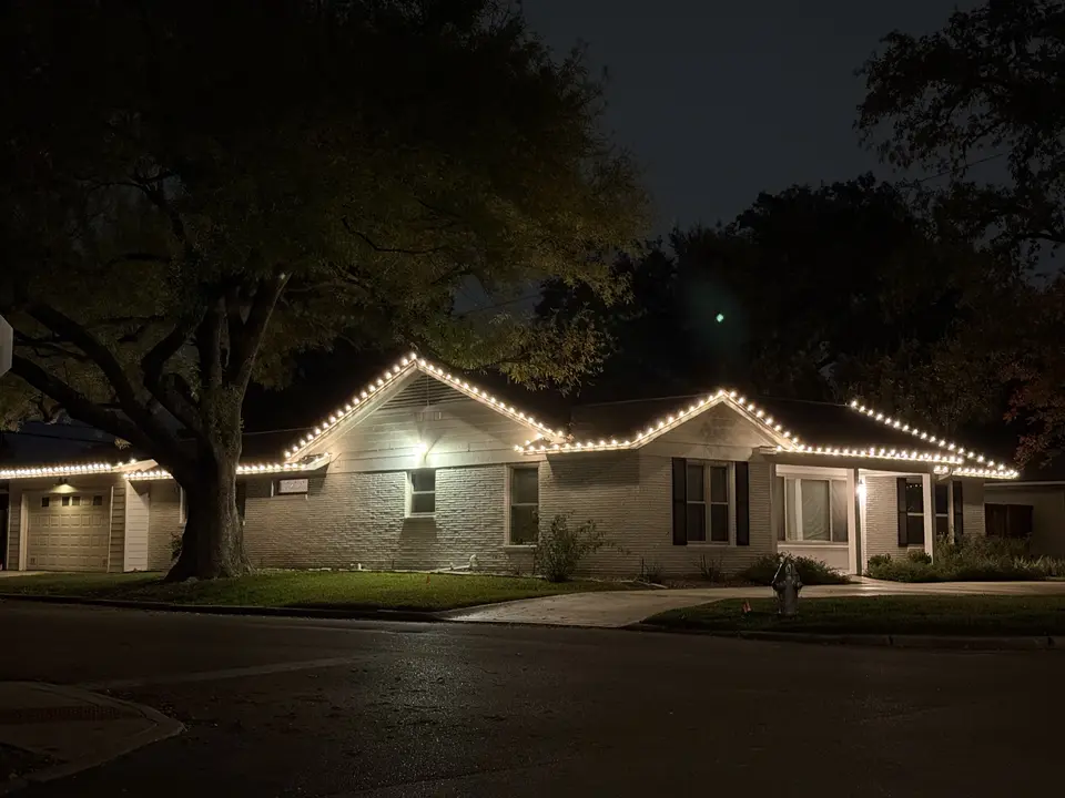 Christmas lights along the roofline · After