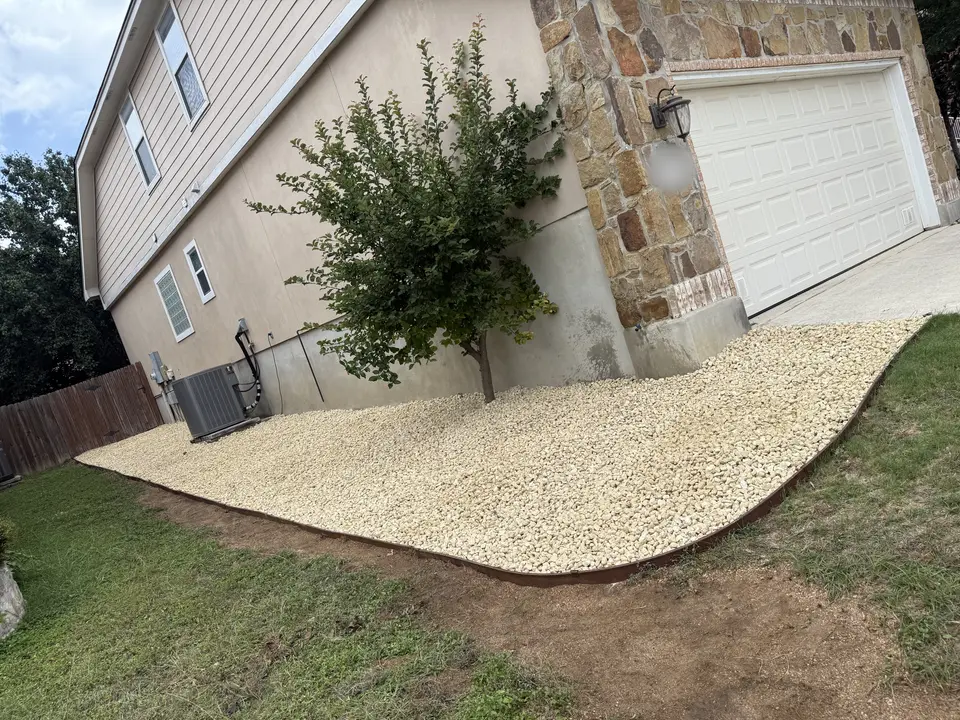 Decorative rock along the side of the house · After